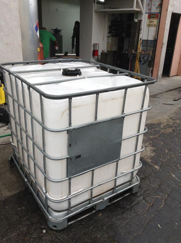 Image of Caged White Plastic Water Tank